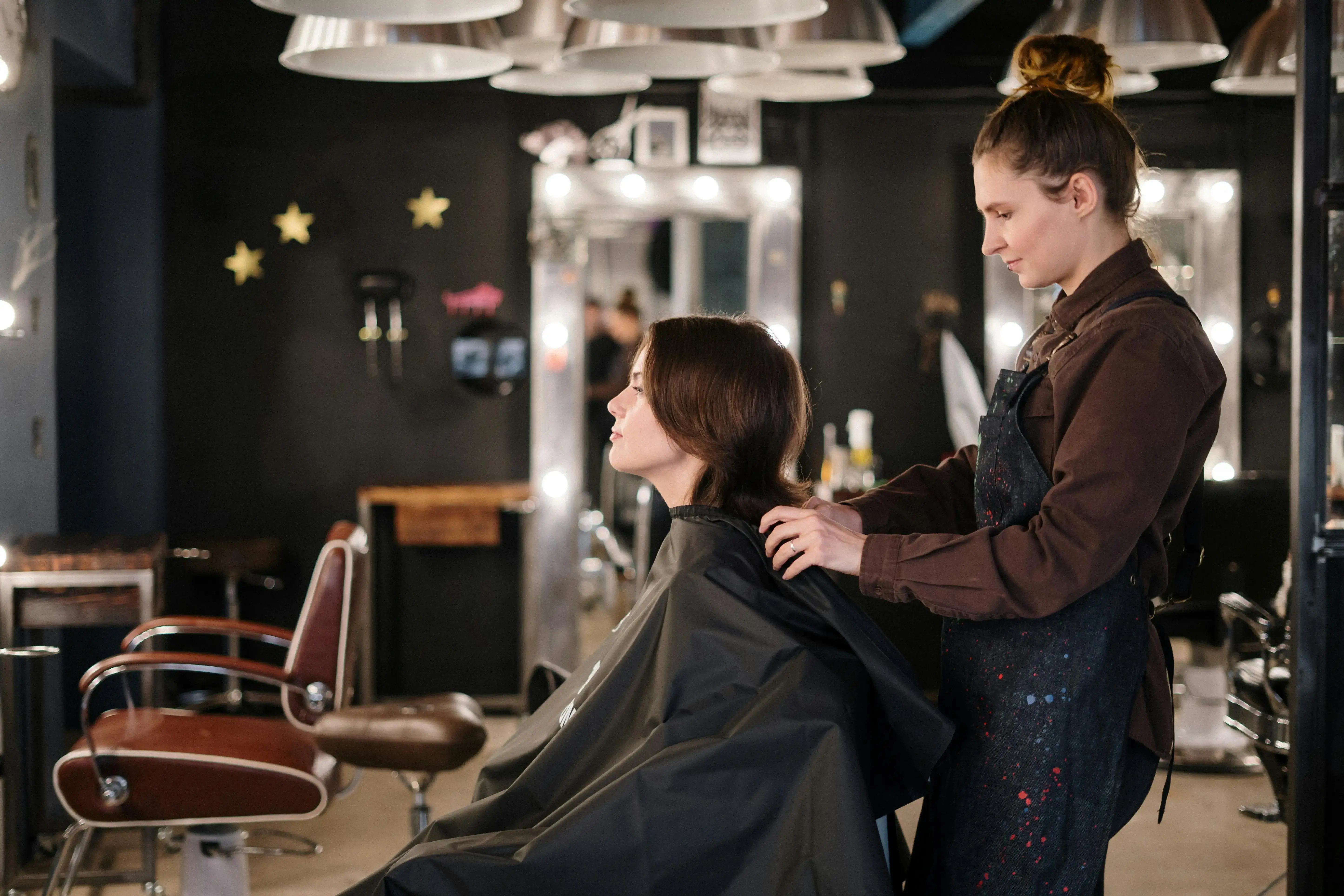 Stylist working on a client's hair in a modern salon