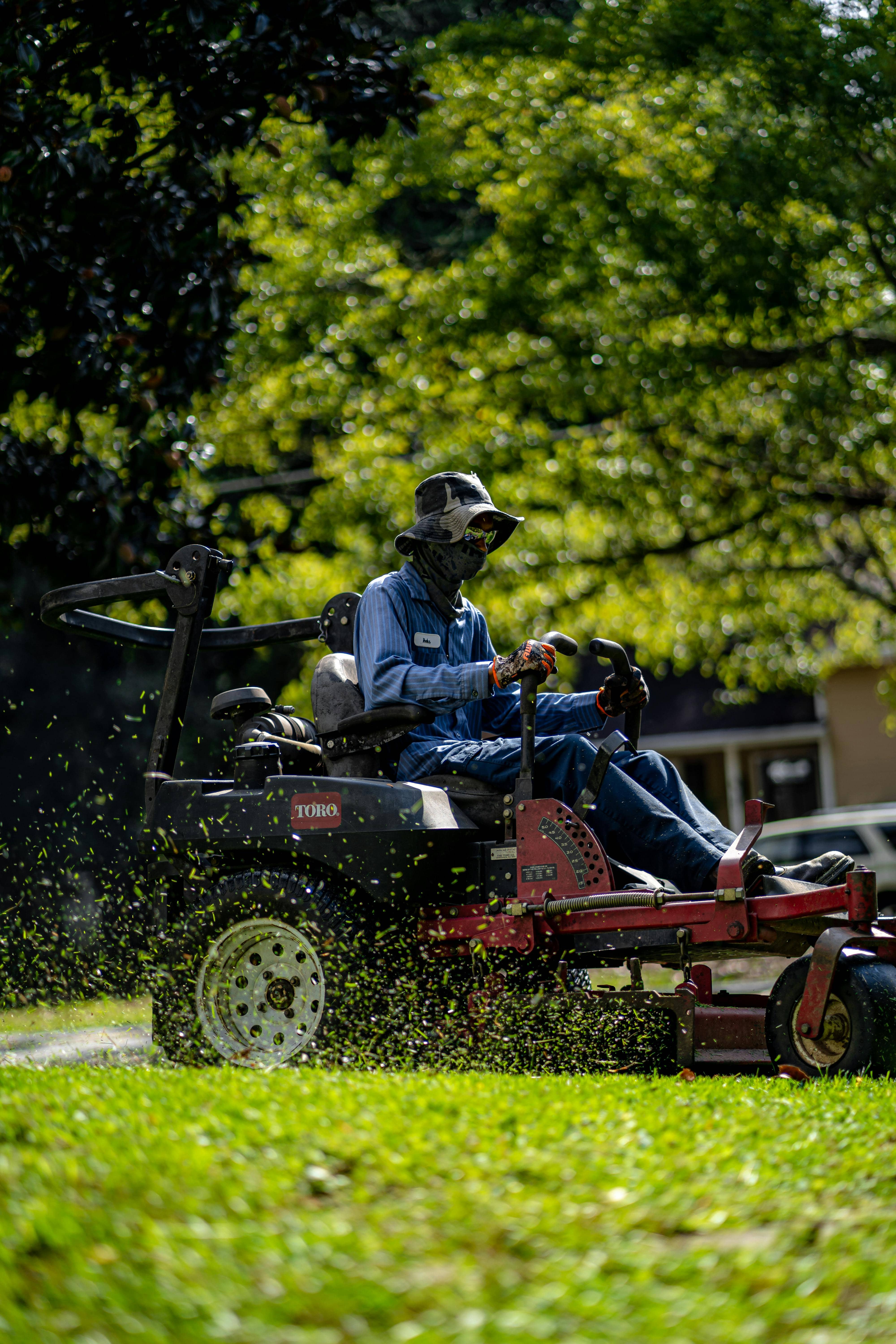 Landscaper manicuring a lawn in a residential neighborhood