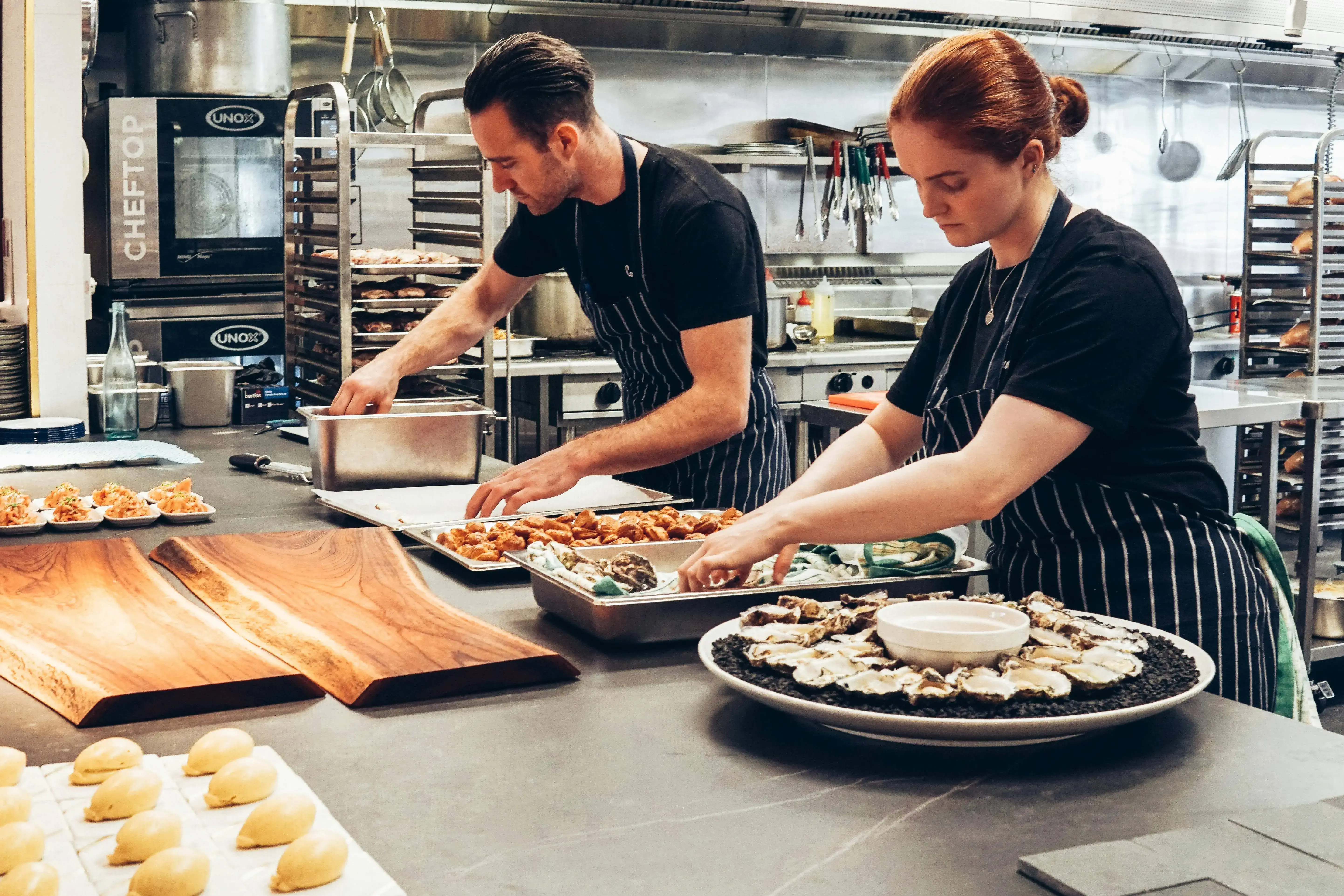 Waitstaff serving food to happy diners in a restaurant